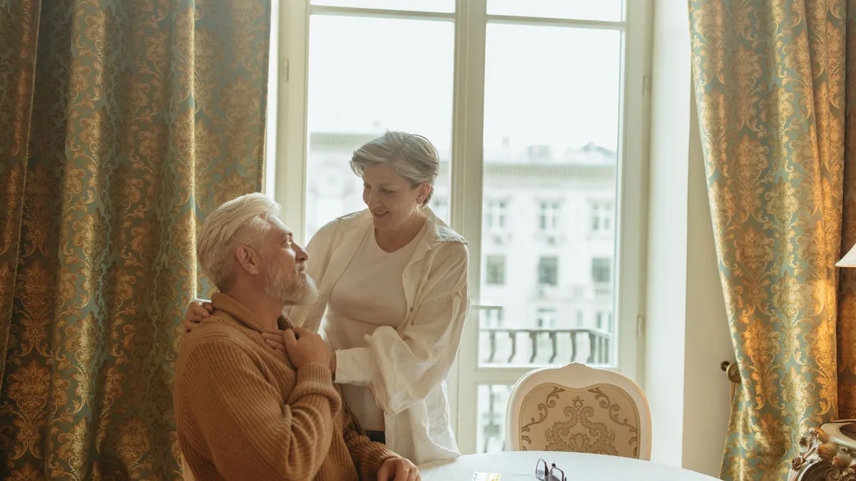 Elderly couple enjoying a heartfelt moment at home, embodying care and companionship.